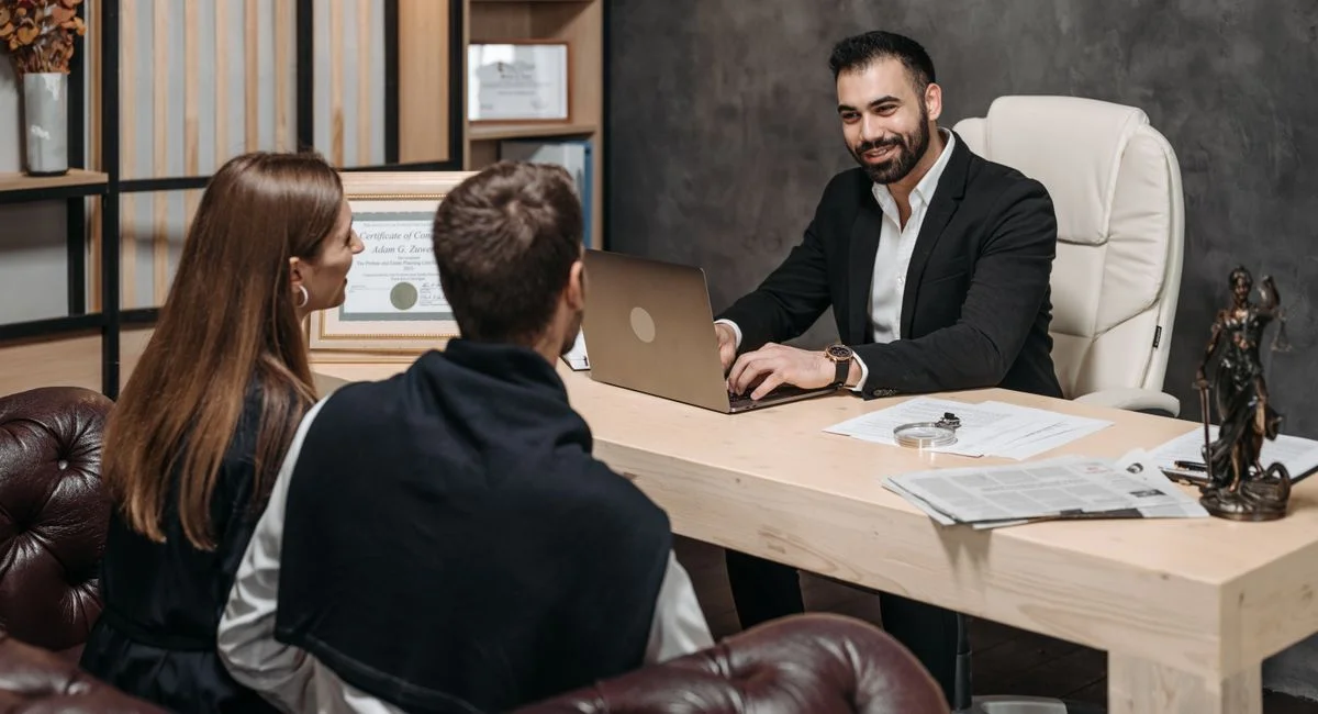 A professional meeting with a lawyer consulting clients in an upscale office environment.