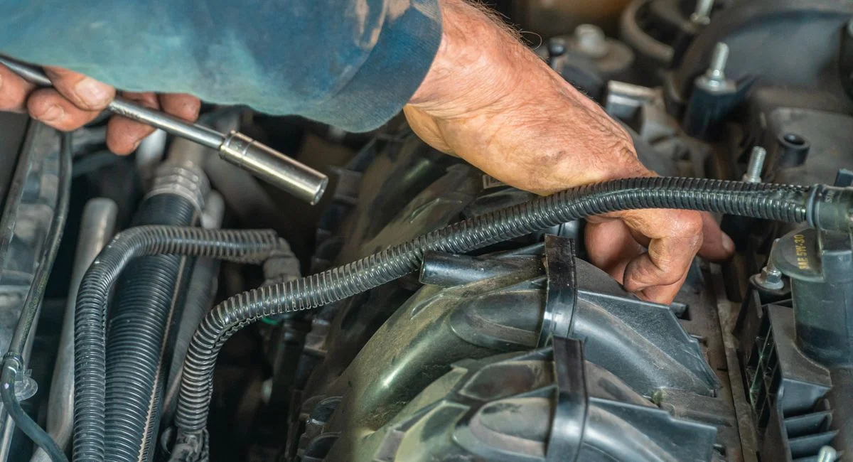 Detailed image of a mechanic repairing a car engine, showcasing technical expertise.