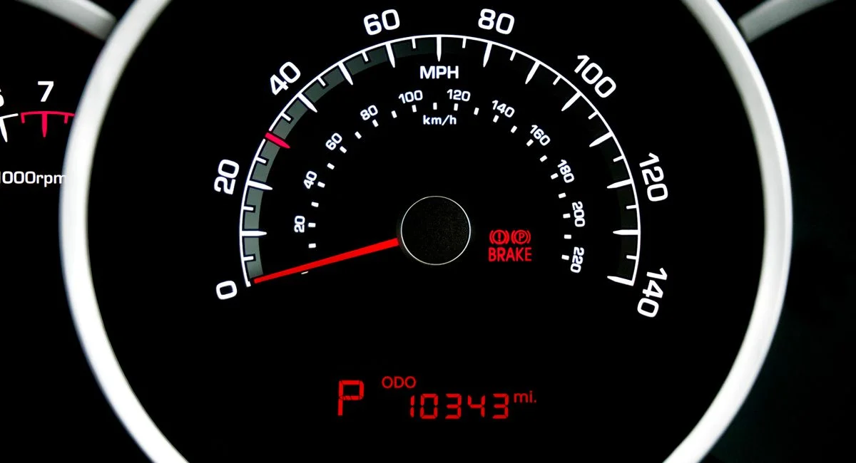 Close-up view of a car speedometer showing speed in MPH and odometer reading 10343 miles.